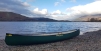 The Enigma Canoes Prospector 16 On The Bank Showing Off Its Hull Rocker